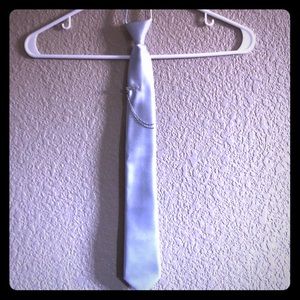 Silver tie with silver accessory